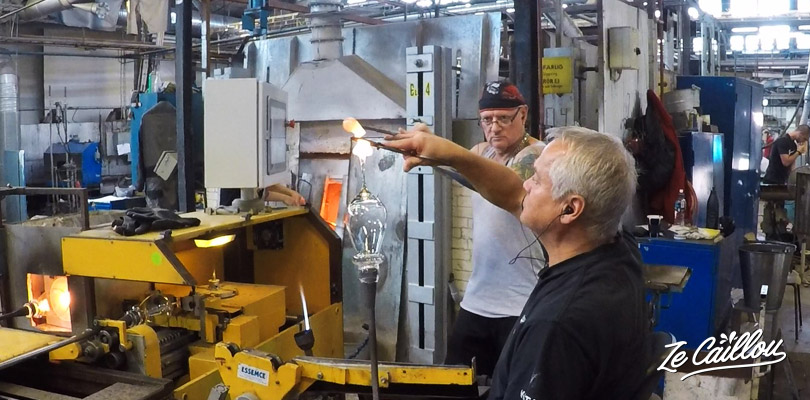 Look the glass blowers working with the molten glass in Sweden