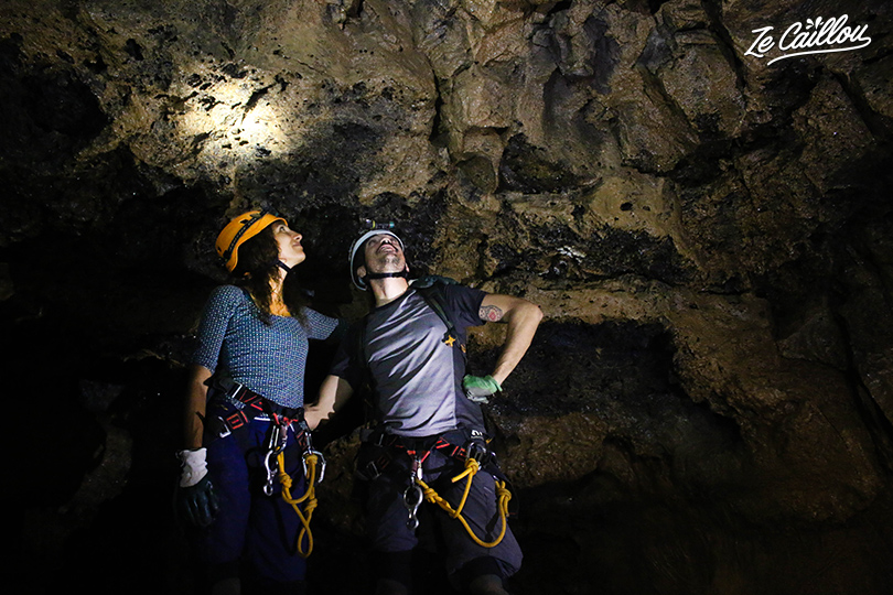 Romain and Nina from Ze Caillou exploring the Bassin bleu lava tunnel in La Reunion.
