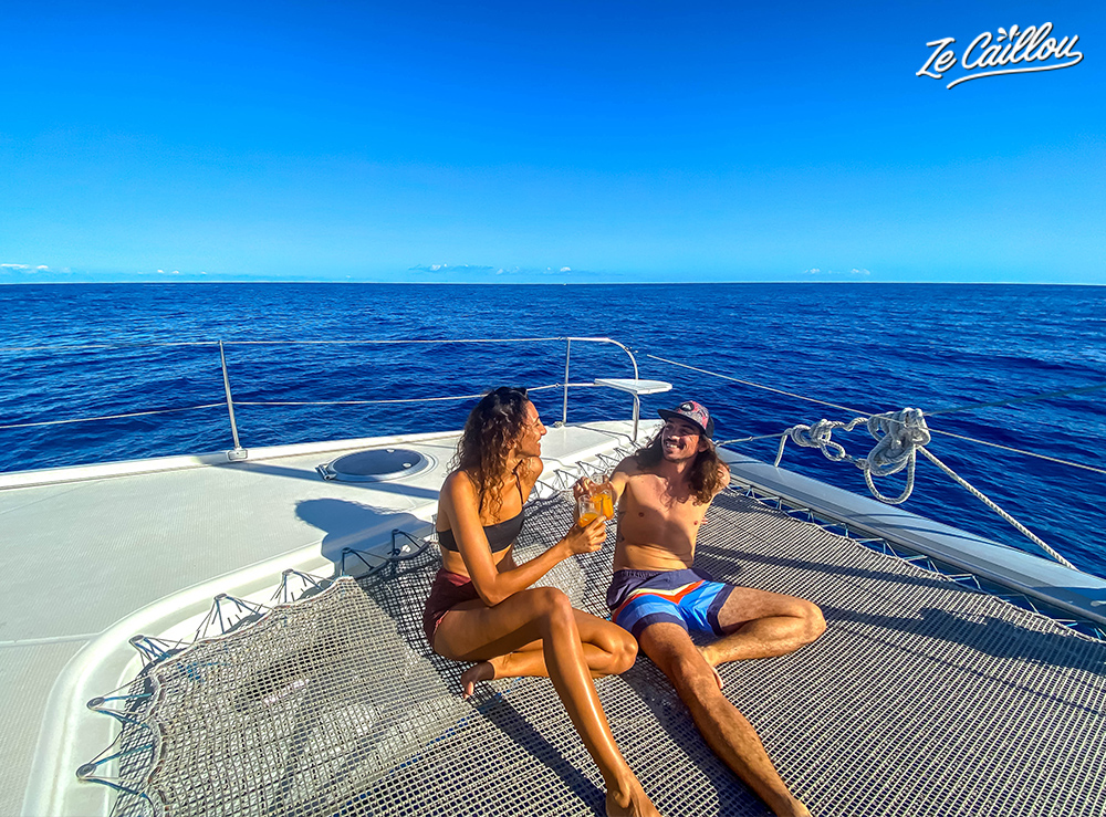 We enjoy this really relaxing chill trip on a catamaran, taking a sunbath on the boat.
