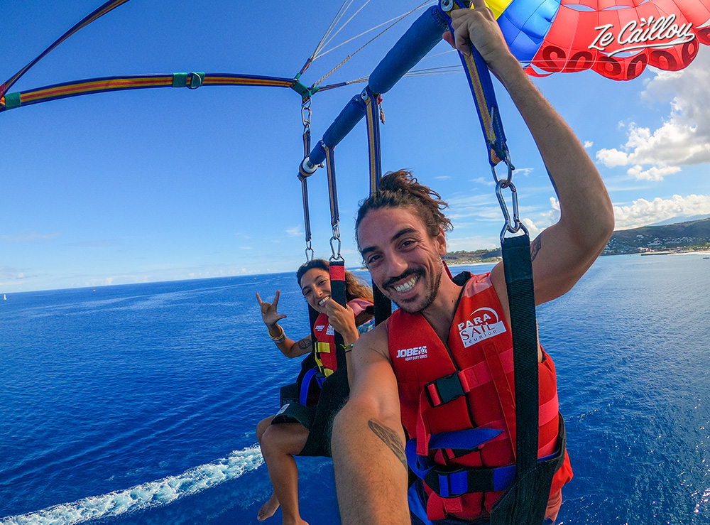 We fly over the sea in a parasailing in Reunion.