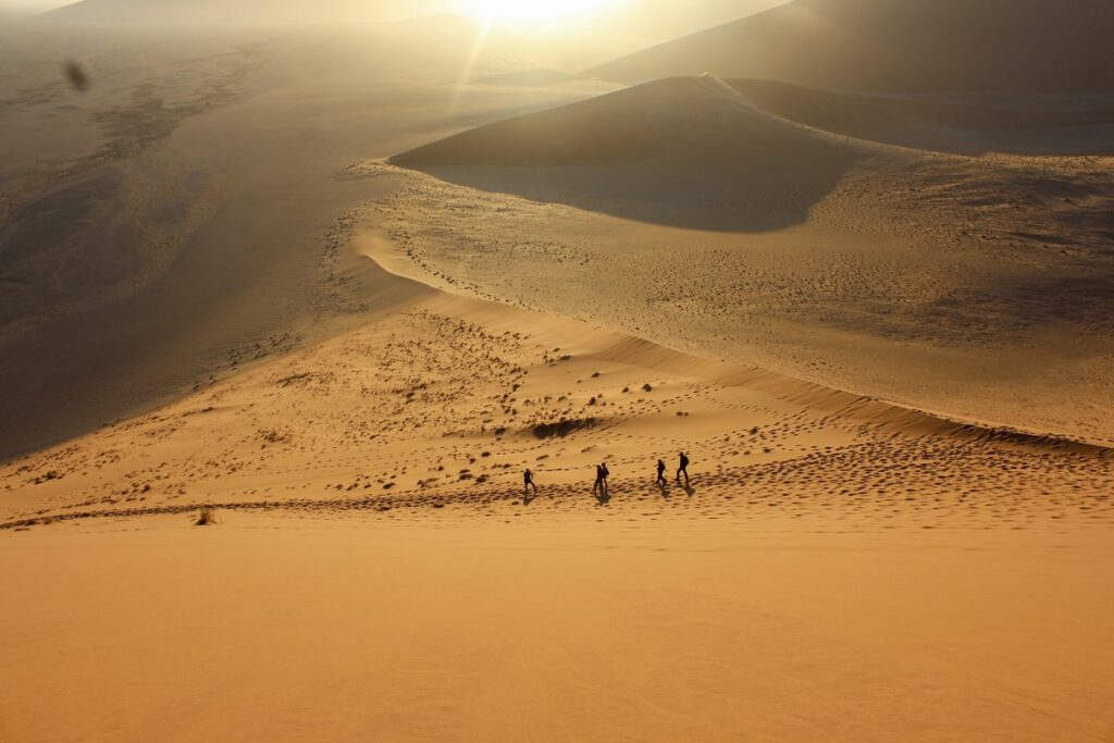 Magnificent sunrise on dune 45 at sossusvlei in Namibia on our travel blog.